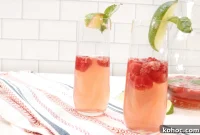 Raspberry Champagne Cocktail with Lime and Fresh Herbs