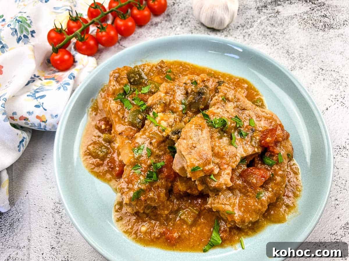 23 Dump-and-Go Slow Cooker Recipes That Taste Homemade 12 Slow Cooker Swiss Pork Chops on a baby blue serving dish.