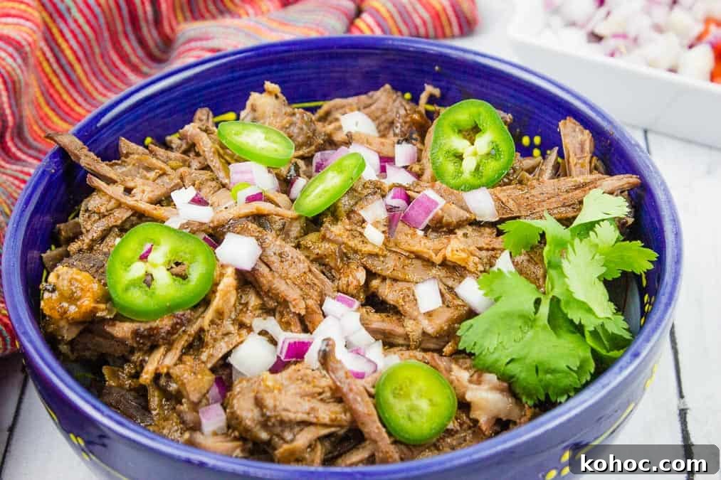 23 Dump-and-Go Slow Cooker Recipes That Taste Homemade 14 Beef Barbacoa in a blue bowl.