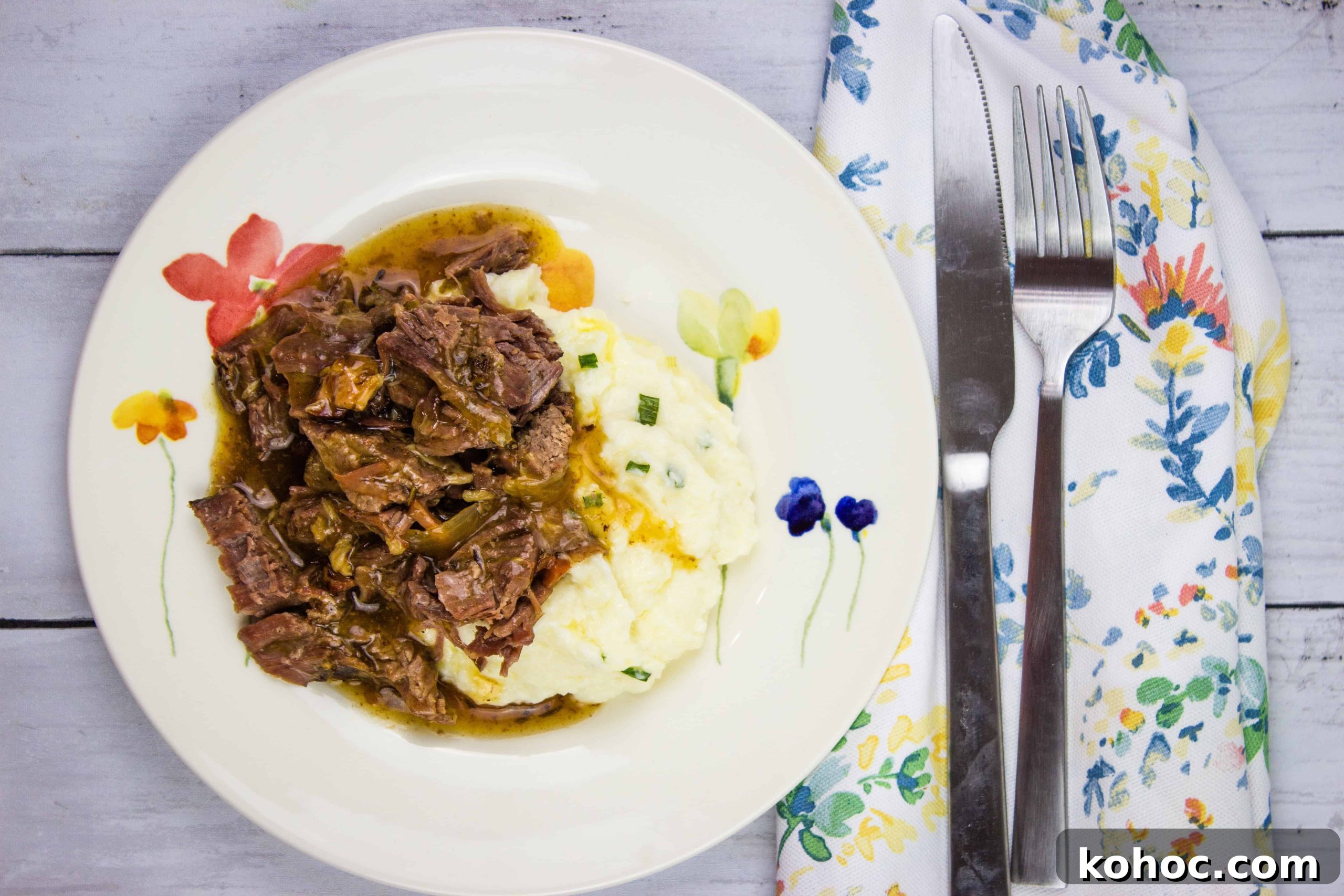 23 Dump-and-Go Slow Cooker Recipes That Taste Homemade 17 A plate of pot roast with bacon and mashed potatoes with gravy.