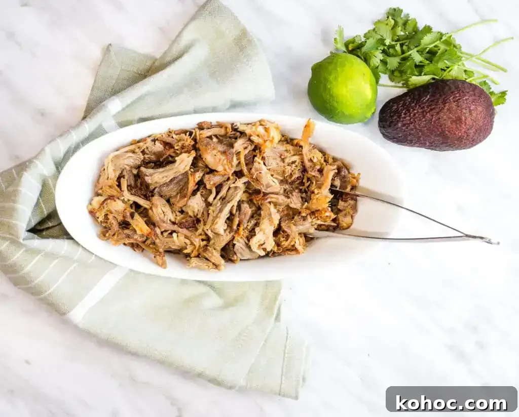 23 Dump-and-Go Slow Cooker Recipes That Taste Homemade 23 Al Pastor Carnitas in a white bowl with tongs.