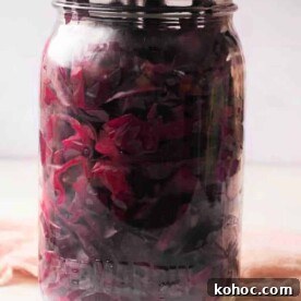 Crisp Pickled Red Cabbage Recipe for Tangy Homemade Slaw 6 A jar of purple pickled cabbage with a metal lid rests on a light surface, showcasing the vibrant color and tangy aroma reminiscent of a classic pickled red cabbage recipe.