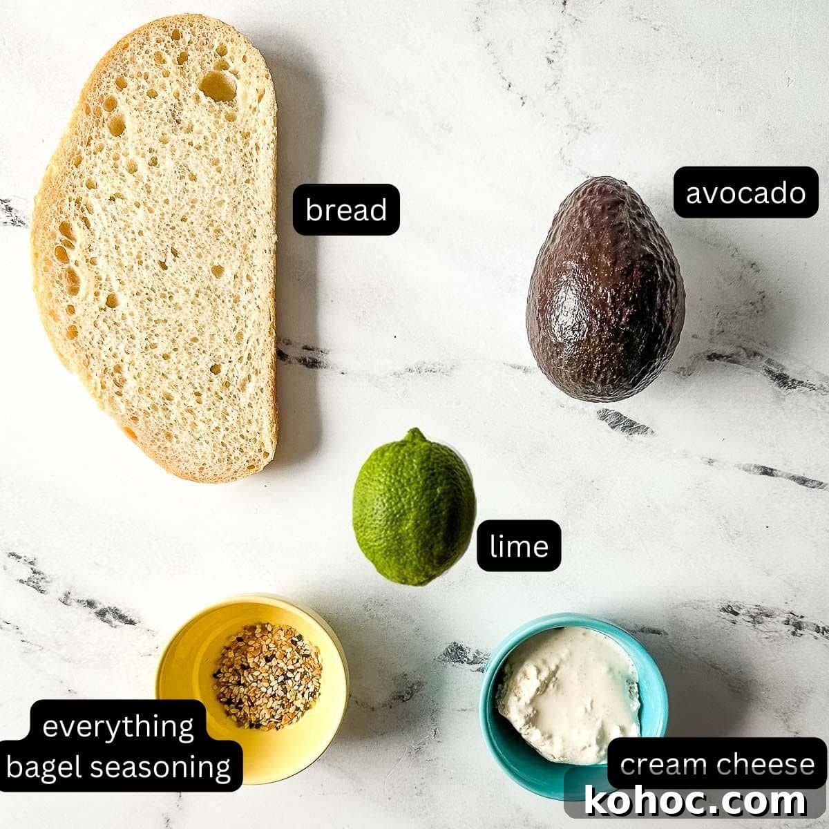 Creamy Avocado Lime Tartine Recipe for Fresh Breakfast 3 the labeled ingredients for the avocado tartine sit on a white marble counter.
