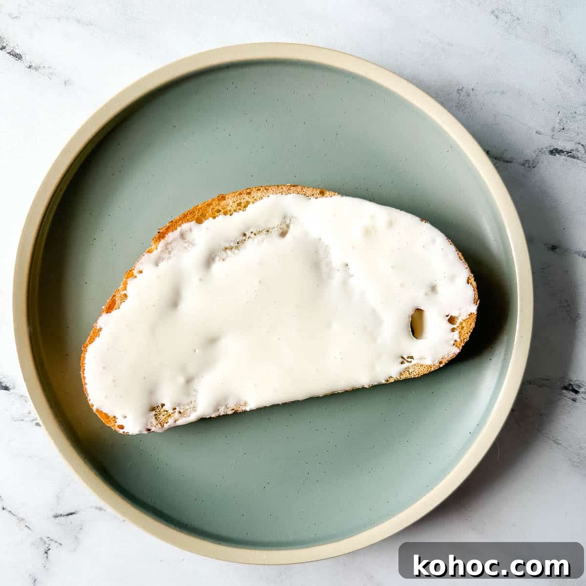 Creamy Avocado Lime Tartine Recipe for Fresh Breakfast 5 Toast spread with cream cheese on a blue plate.