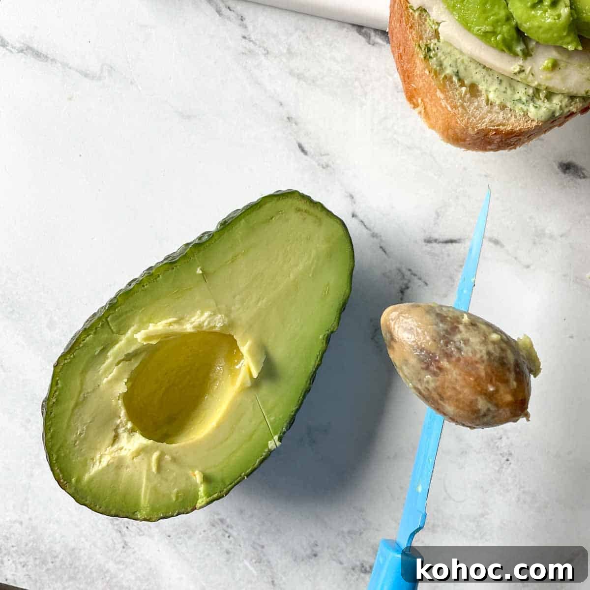 Creamy Avocado Lime Tartine Recipe for Fresh Breakfast 6 The pit is removed from half of an avocado.
