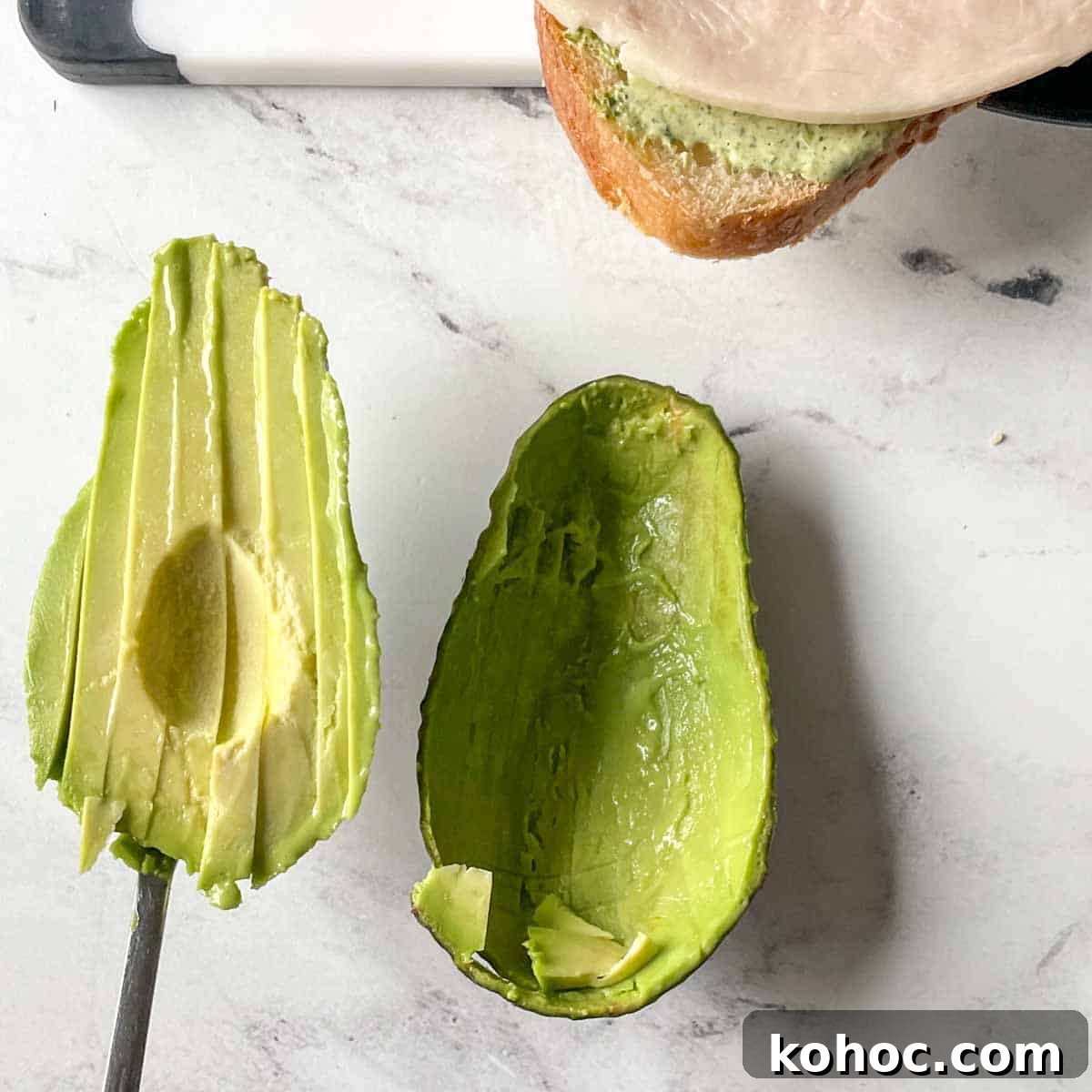 Creamy Avocado Lime Tartine Recipe for Fresh Breakfast 8 Thin slices of avocado are scooped out of their skin.