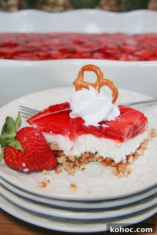 Strawberry Pretzel Dessert is a 3-layered, chilled treat flavored with strawberry Jell-O, cream cheese, and a pretzel crust. A chilled treat garnished with strawberries, whipped topping, and a pretzel.