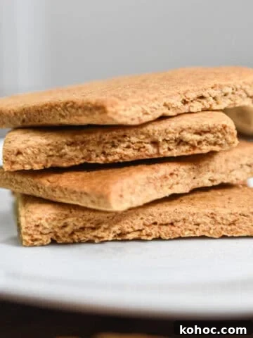 The sourdough graham crackers are stacked on top of each other on a white plate.