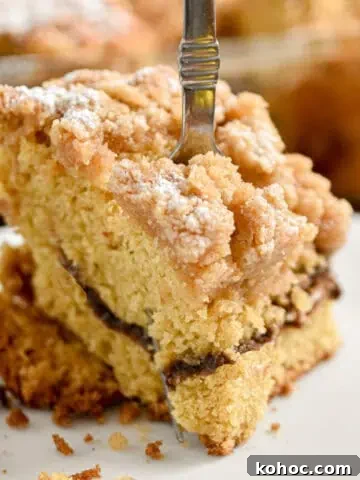 A fork is going through a piece of the sourdough coffee cake.