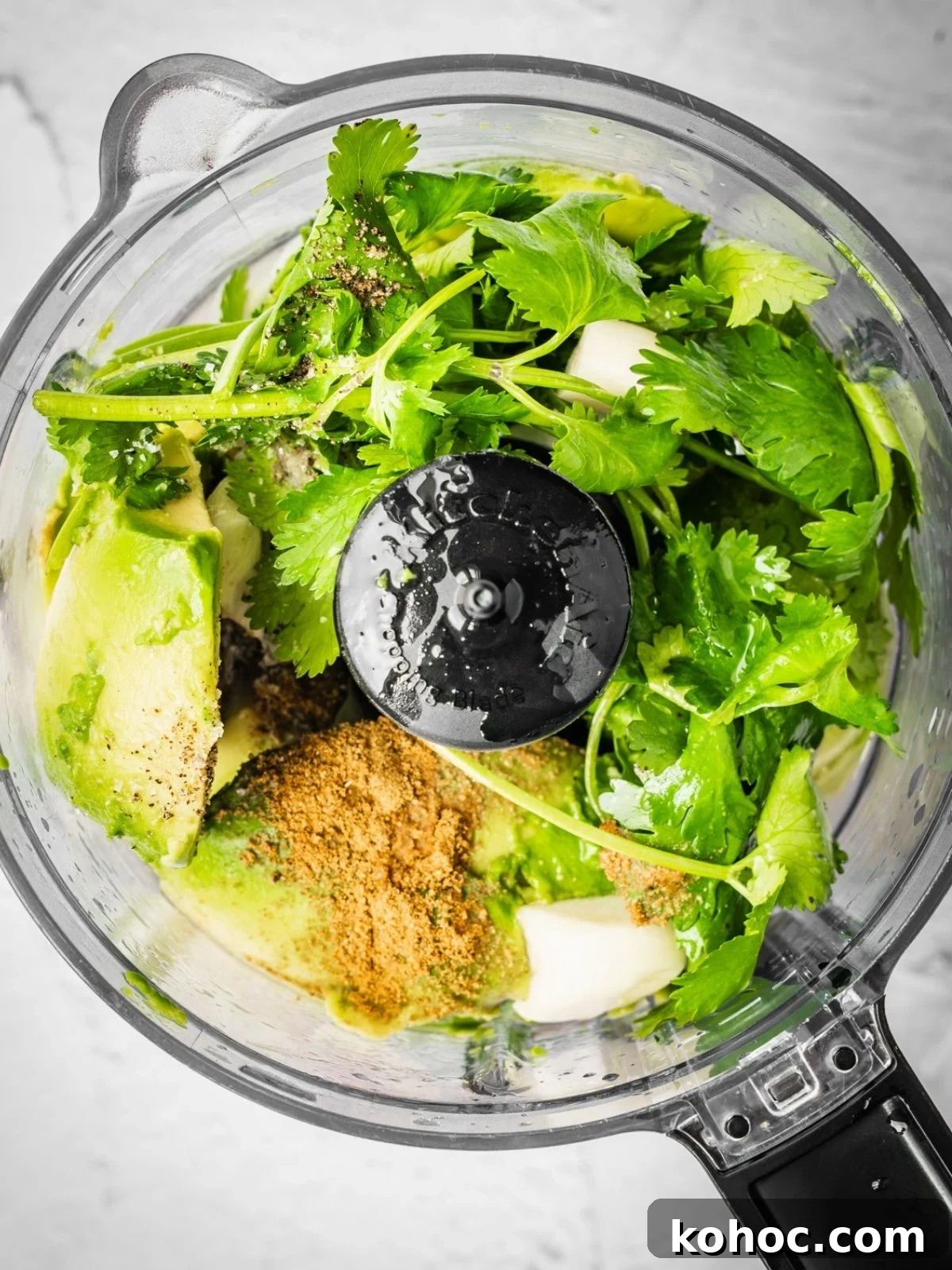 Salsa de aguacate recipe step showing the food processor with all the ingredients.