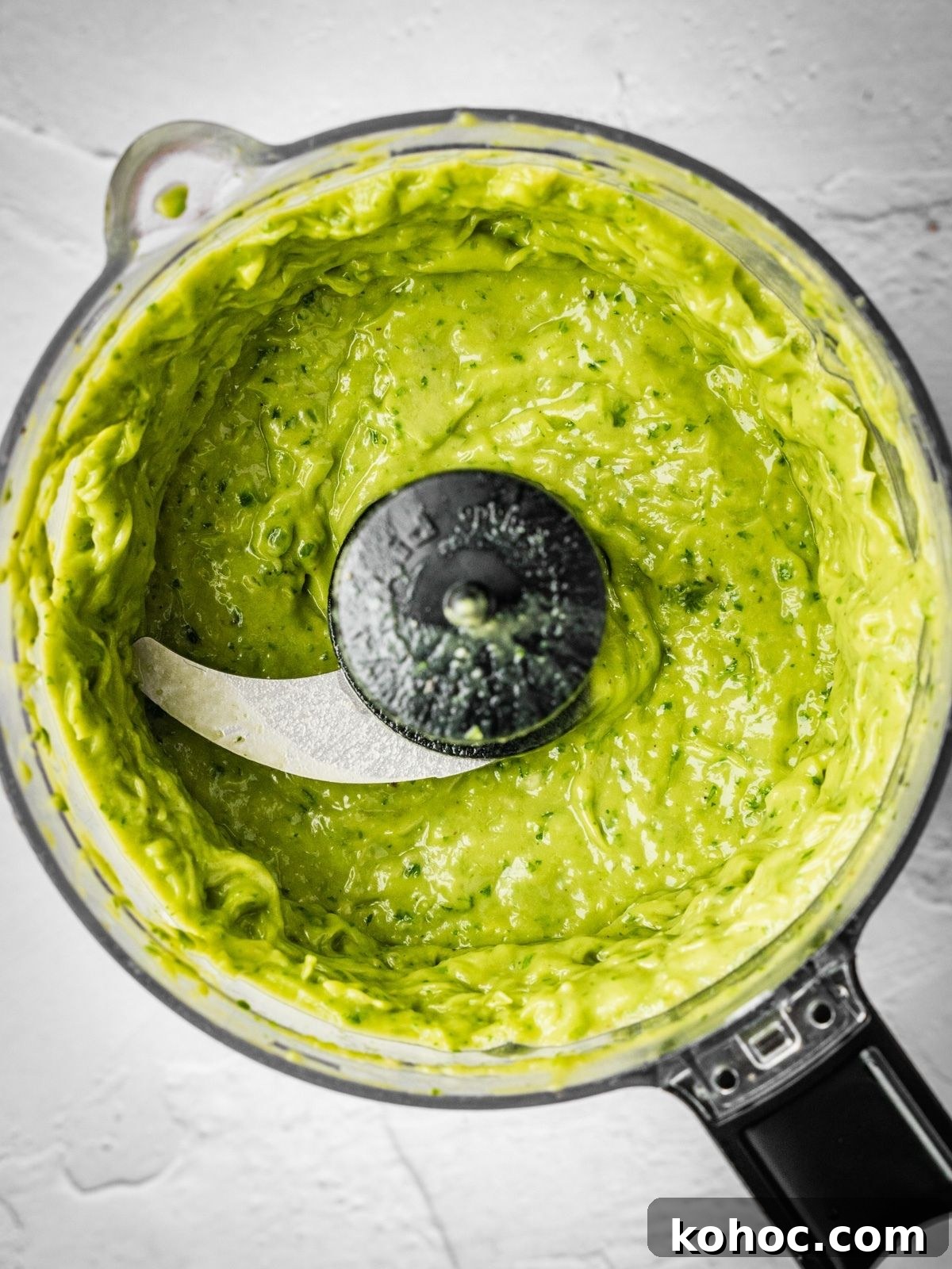 Salsa de aguacate recipe step showing the processed sauce in the food processor.