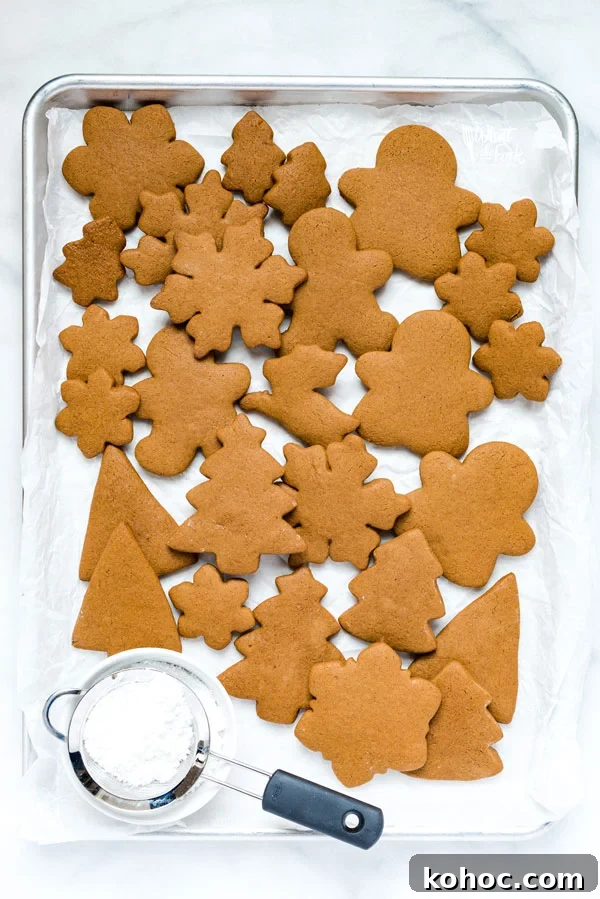 Gluten-Free Gingerbread Cookies Recipe for Perfect Holiday Bakes 3 overhead shot of gluten free gingerbread cookies on a parchment paper lined baking sheet