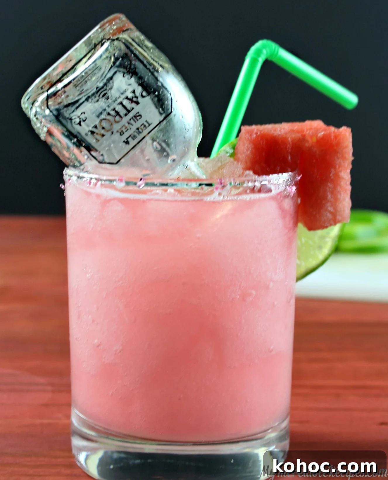 Refreshing Watermelon Margarita Recipe for Summer Cocktails 3 close up of watermelon margarita on a wood table with a mini bottle of patron inside