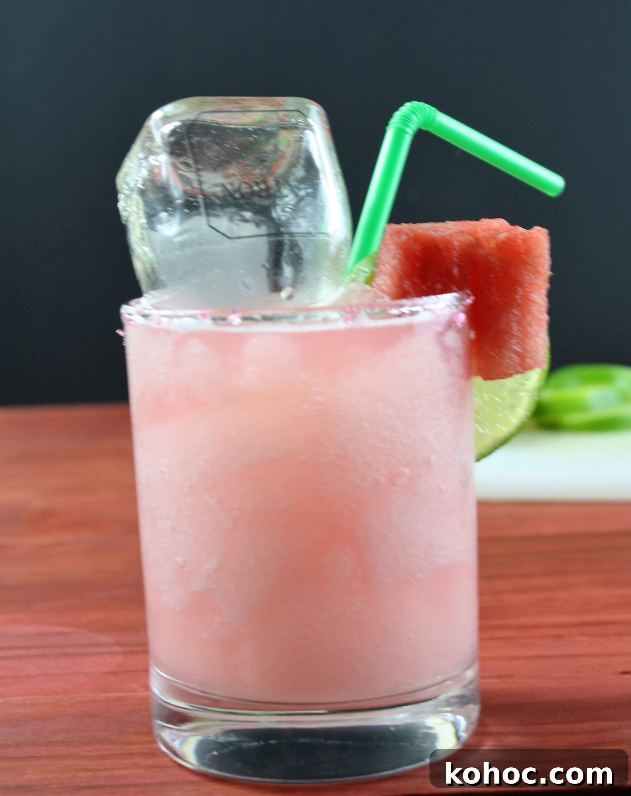 Refreshing Watermelon Margarita Recipe for Summer Cocktails 5 watermelon margarita on a wood table with a mini bottle of patron inside