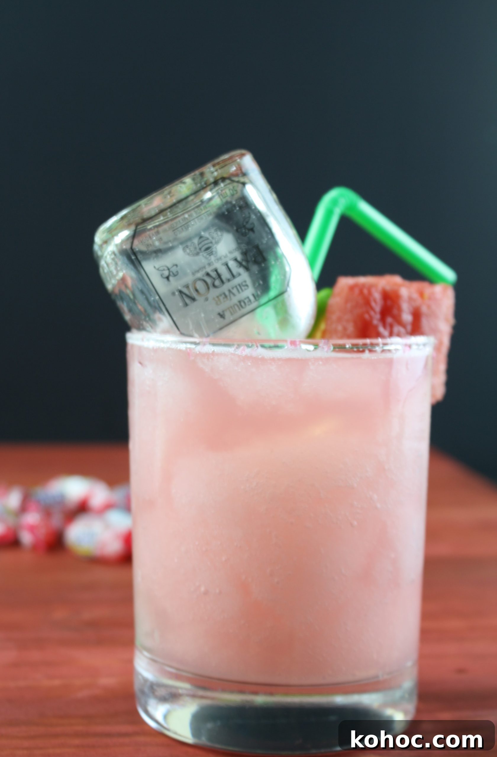 Refreshing Watermelon Margarita Recipe for Summer Cocktails 7 watermelon margarita on a wood table with a mini bottle of patron inside