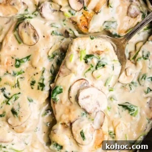 Creamy Garlic Pork Chops with Lighter Sauce 13 Creamy garlic pork chops in a pan with a large spoon.