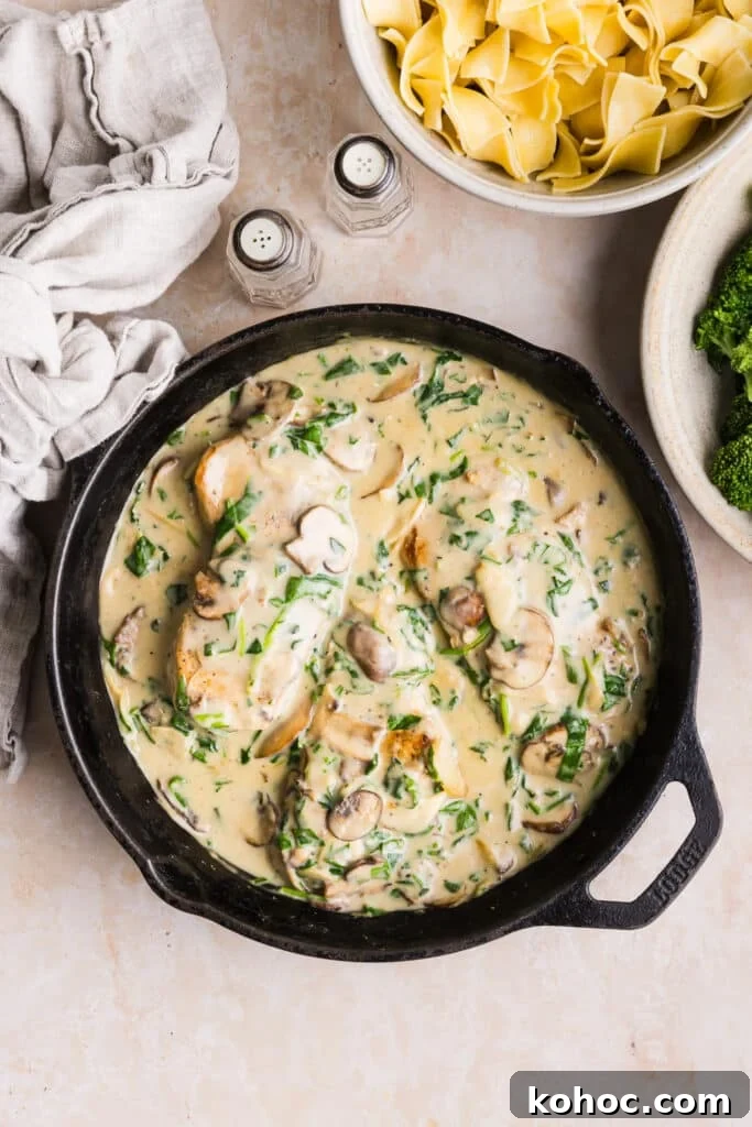 Creamy Garlic Pork Chops with Lighter Sauce 10 Creamy garlic pork chops in a pan with spinach and mushrooms.