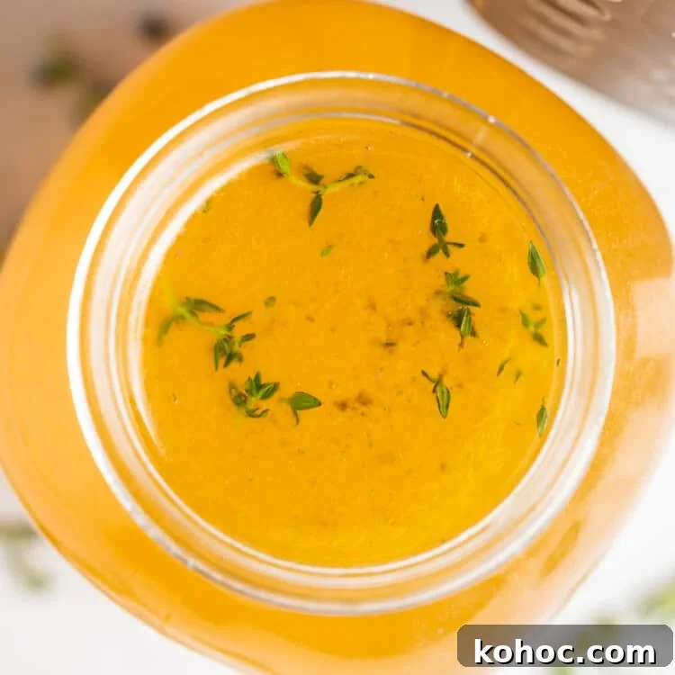 overhead image of instant pot turkey stock with fresh herbs on the side