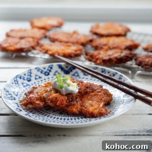 Cheesy Kimchi Potato Pancakes Recipe for Crispy, Flavorful Korean-Style Pancakes 13 Cheesy Kimchi Potato Pancakes are garnished with a dollop of sour cream.