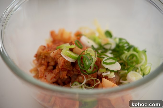Cheesy Kimchi Potato Pancakes Recipe for Crispy, Flavorful Korean-Style Pancakes 6 Kimchi and green onion in a bowl.