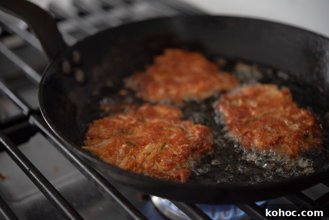Cheesy Kimchi Potato Pancakes Recipe for Crispy, Flavorful Korean-Style Pancakes 10 Kimchi Cheese Potato frying in a skillet.