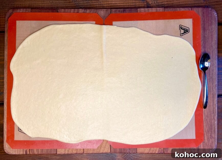 Soft Homemade Cinnamon Rolls with Cream Cheese Glaze 10 Dough rolled out on silicone mats.
