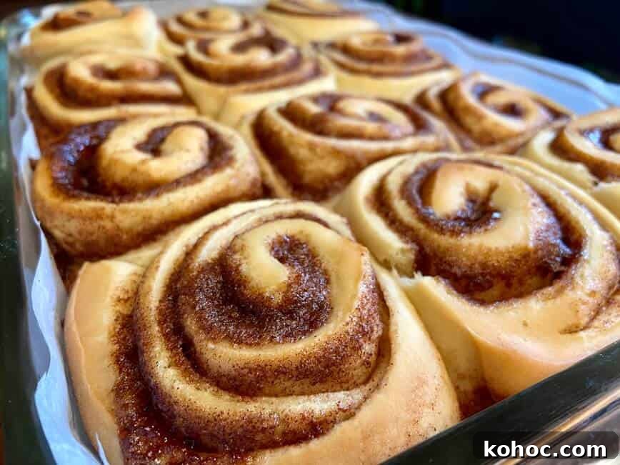 Soft Homemade Cinnamon Rolls with Cream Cheese Glaze 13 Baked rolls in baking pan.
