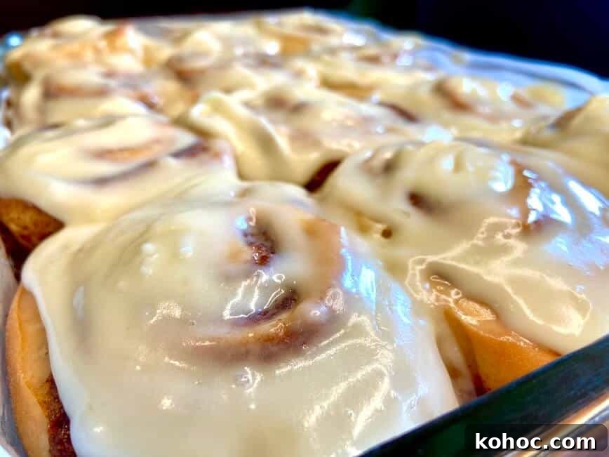 Soft Homemade Cinnamon Rolls with Cream Cheese Glaze 15 Finished rolls, with melted icing on top, ready to serve.