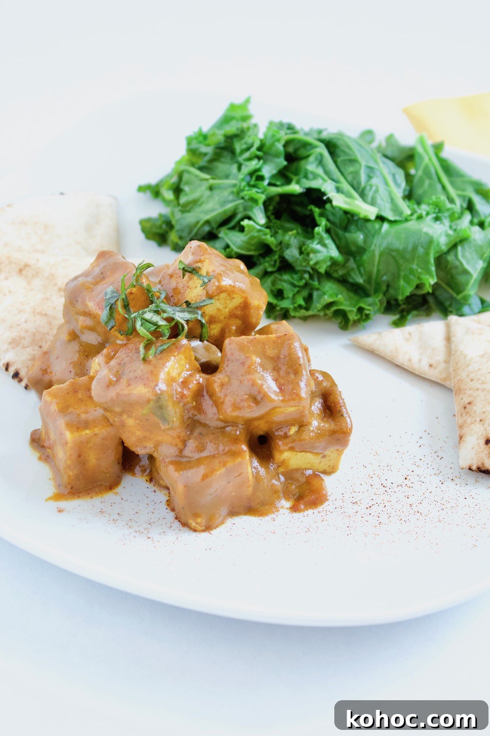 Creamy Vegetarian Tofu Paprikash with Bell Peppers and Paprika 2 Vegetarian Tofu Paprikash Recipe on Plate with Kale