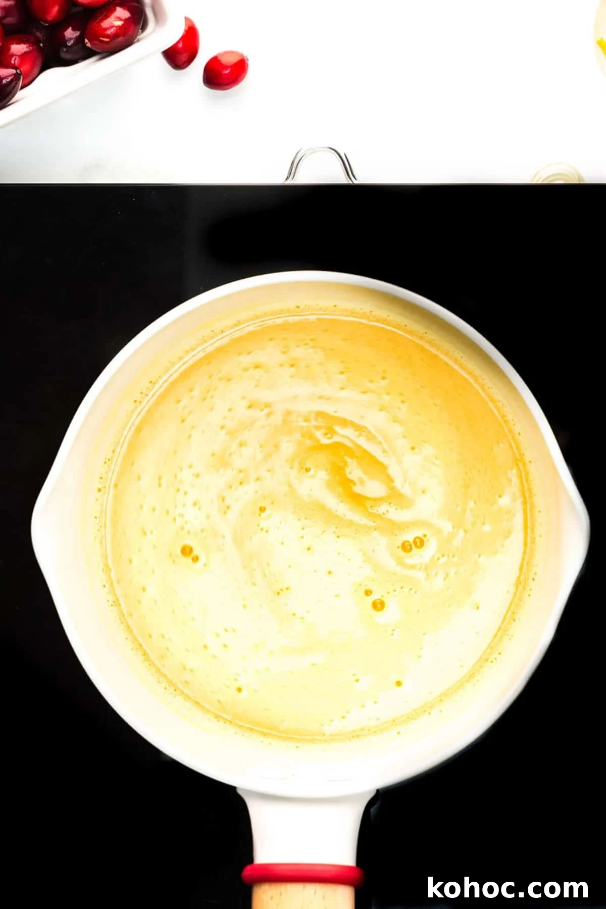 Overhead view of water, orange juice and sugar boiling