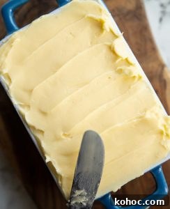 overhead shot of butter in small dish with knife resting on it
