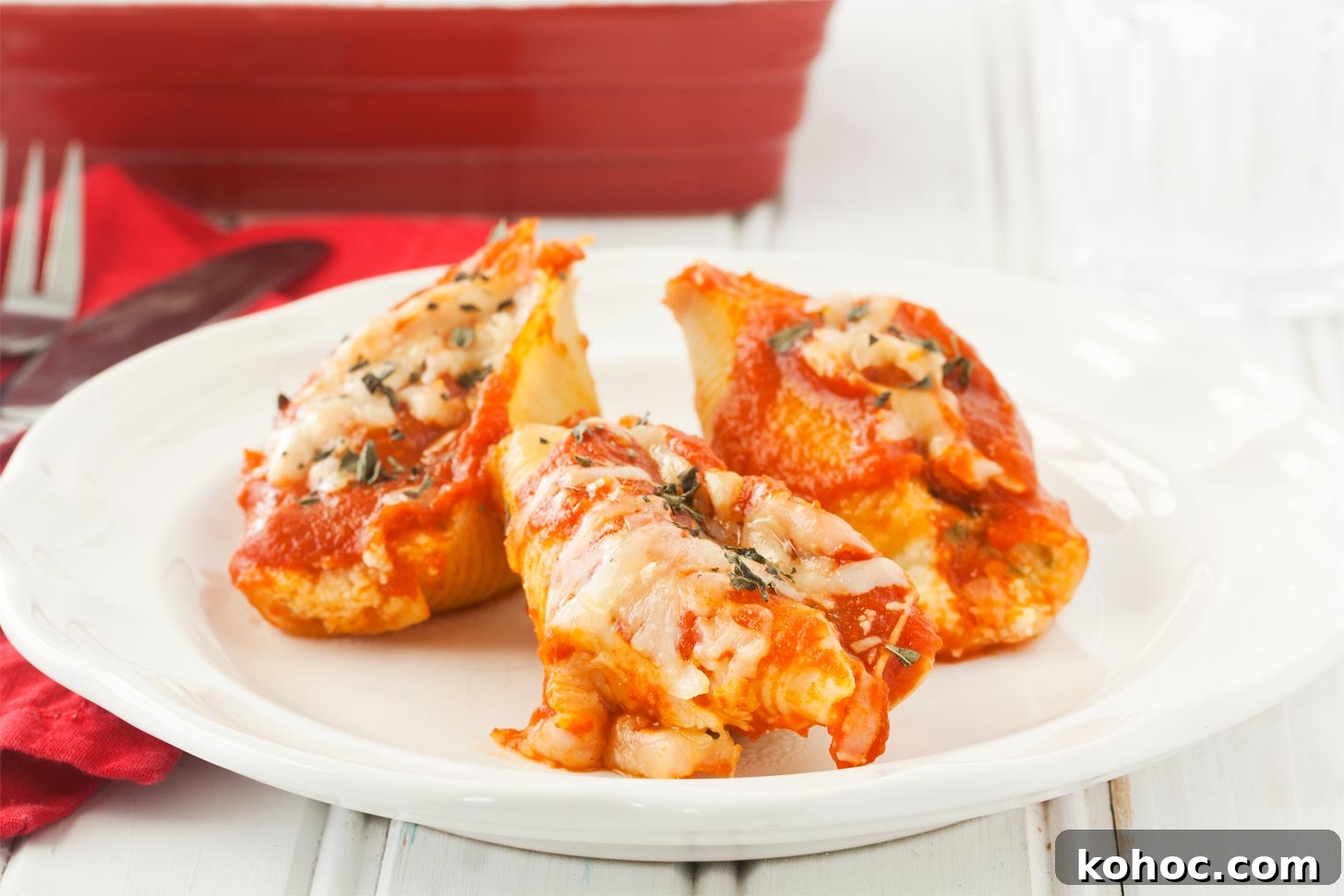 Cheese-Stuffed Pasta Shells Baked with Marinara and Mozzarella 5 Cheese stuffed shells recipe served on white plate