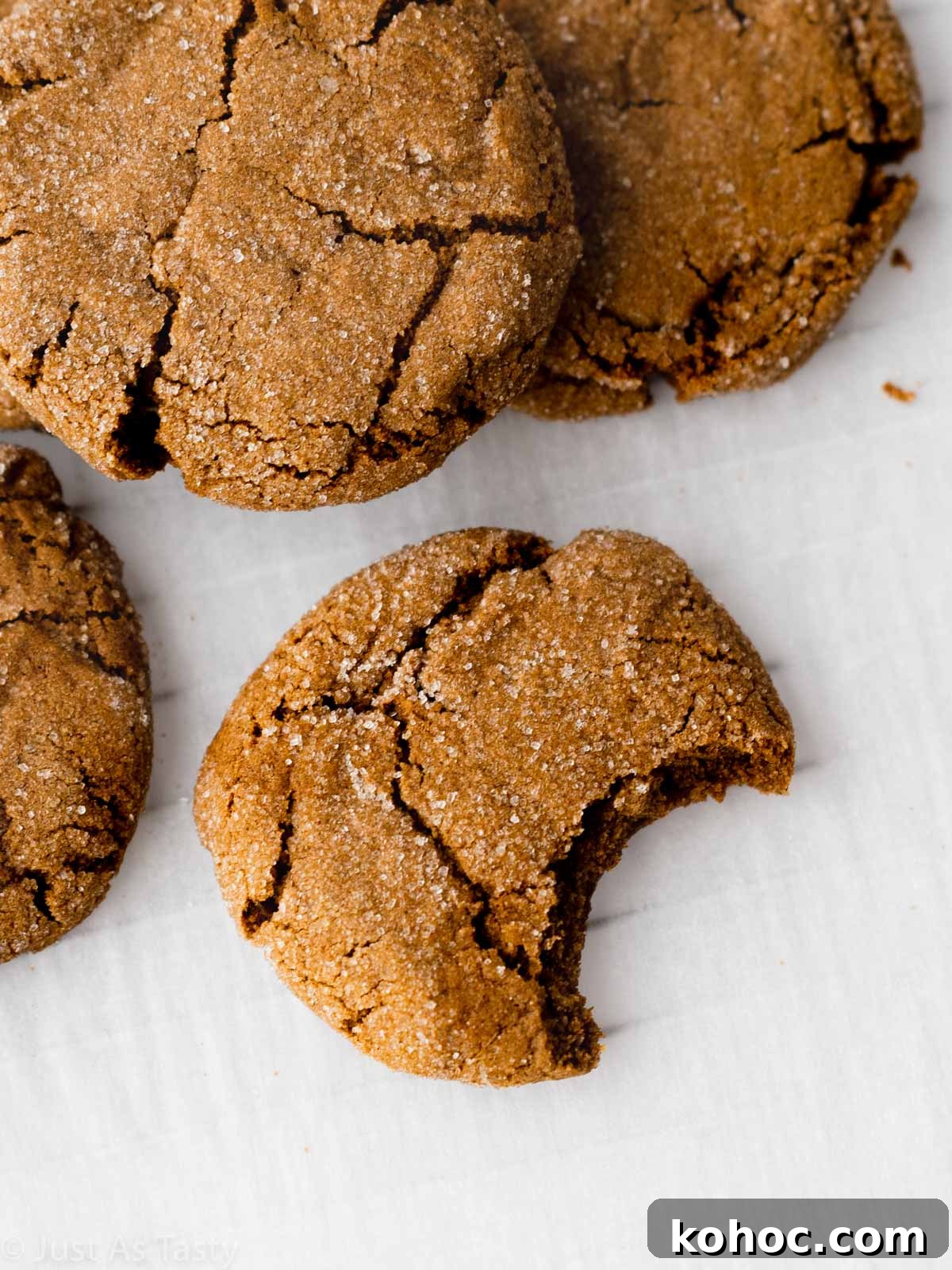 Crispy Gluten-Free Gingersnap Cookies You’ll Love 4 Close-up of a gingersnap cookie with a bite taken out.