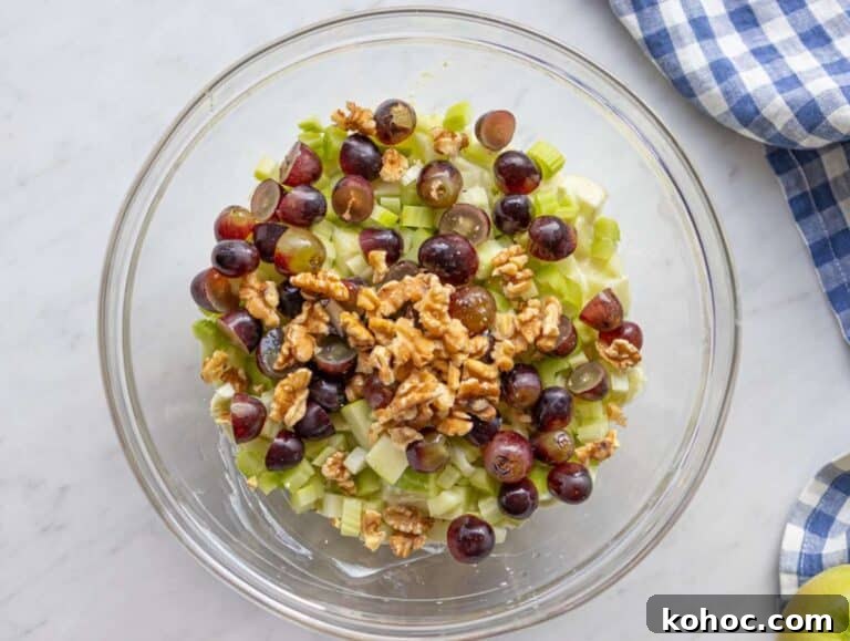 Step 2 Chopped apples celery and grapes tossed with dressing for healthy Waldorf salad.