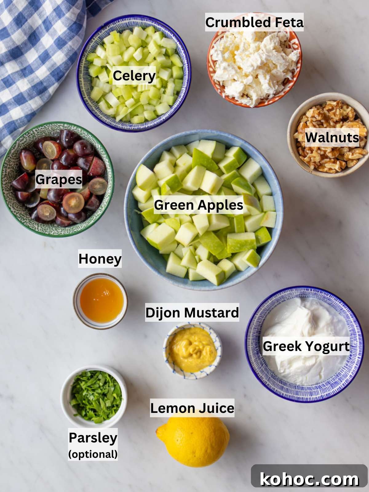 Waldorf Salad with Greek Yogurt Dressing — Light Apple & Walnut Salad 3 Ingredients for healthy Waldorf salad arranged on a board with apples celery and grapes.