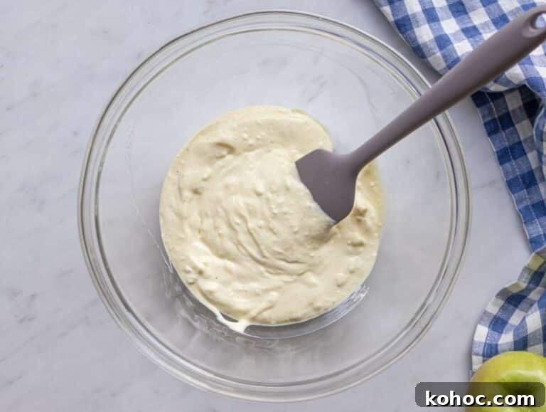 Step 1 Mixing creamy yogurt dressing for healthy Waldorf salad in a large bowl.