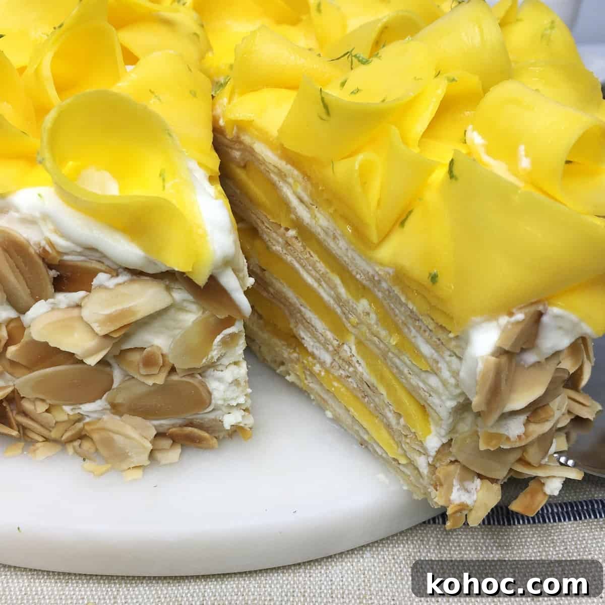 Mango Crepe Cake Recipe: Step-by-Step Guide for Silky Layers 2 Sliced Mille crepe cake on a white marble board: Close up