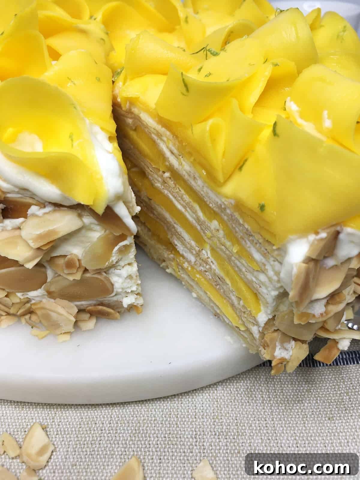 Mango Crepe Cake Recipe: Step-by-Step Guide for Silky Layers 4 Sliced mango cake served on a marble board: Close up