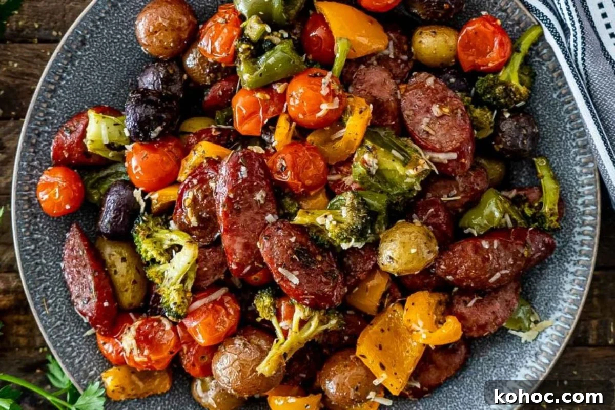 29 Tasty Meals You Can Make with Frozen Vegetables 13 A colorful plate of roasted vegetables and sliced sausages, using frozen vegetables like broccoli, bell peppers, cherry tomatoes, and olives.