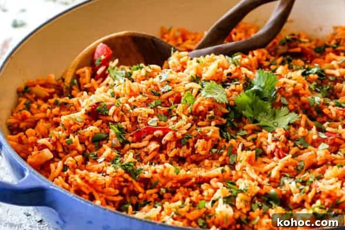 29 Tasty Meals You Can Make with Frozen Vegetables 27 A bowl of rice with frozen vegetables and wooden spoons.