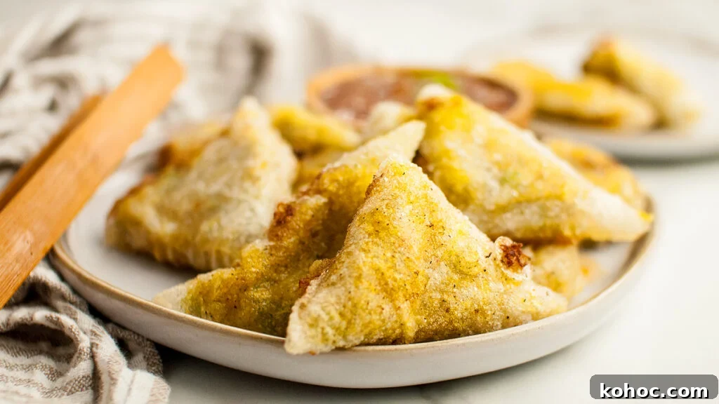 29 Tasty Meals You Can Make with Frozen Vegetables 5 Homemade samosas piled on a white plate.
