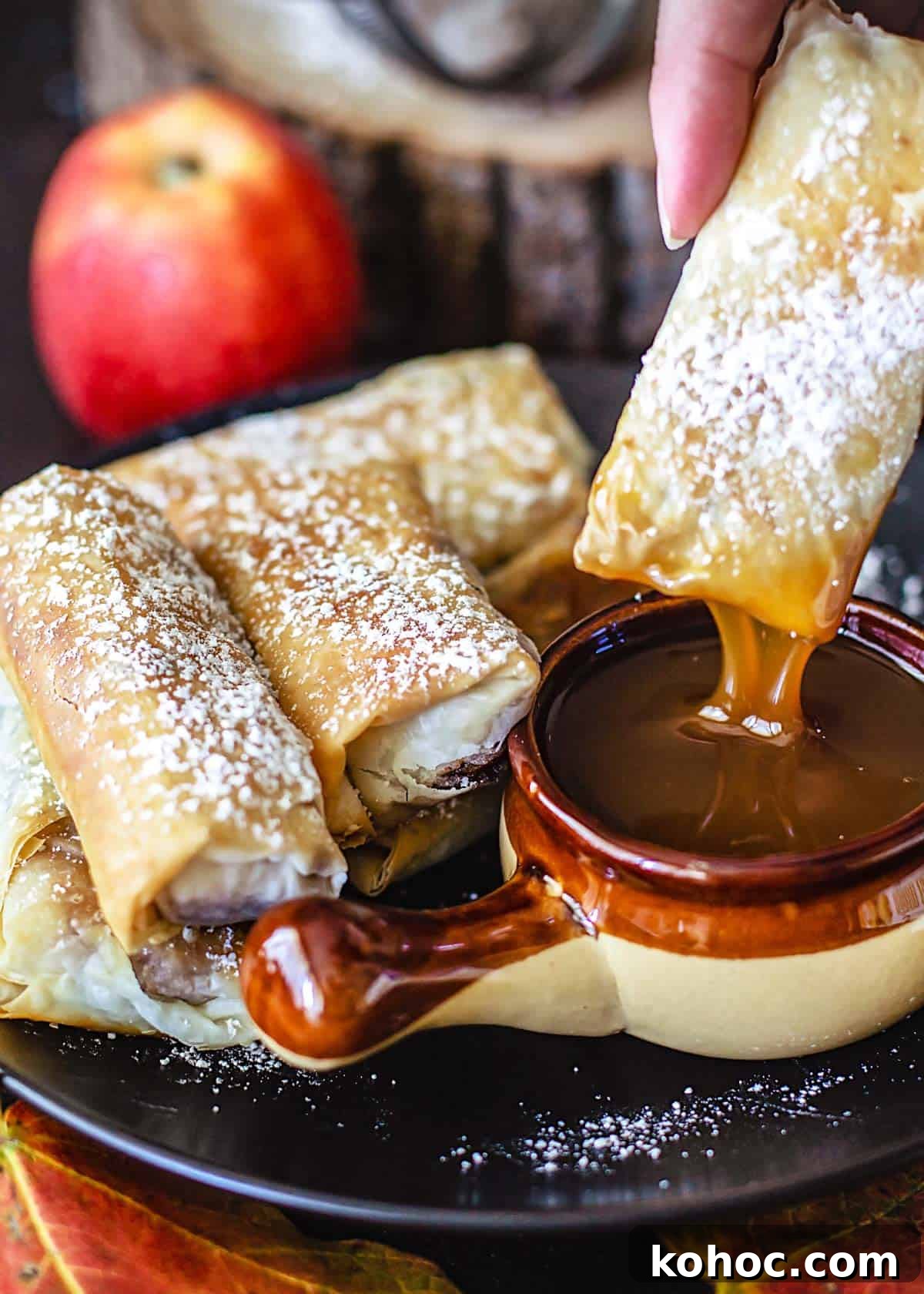 Crispy Apple Pie Spring Rolls with Filo Pastry 2 An apple pie filo roll dipped into a caramel sauce.