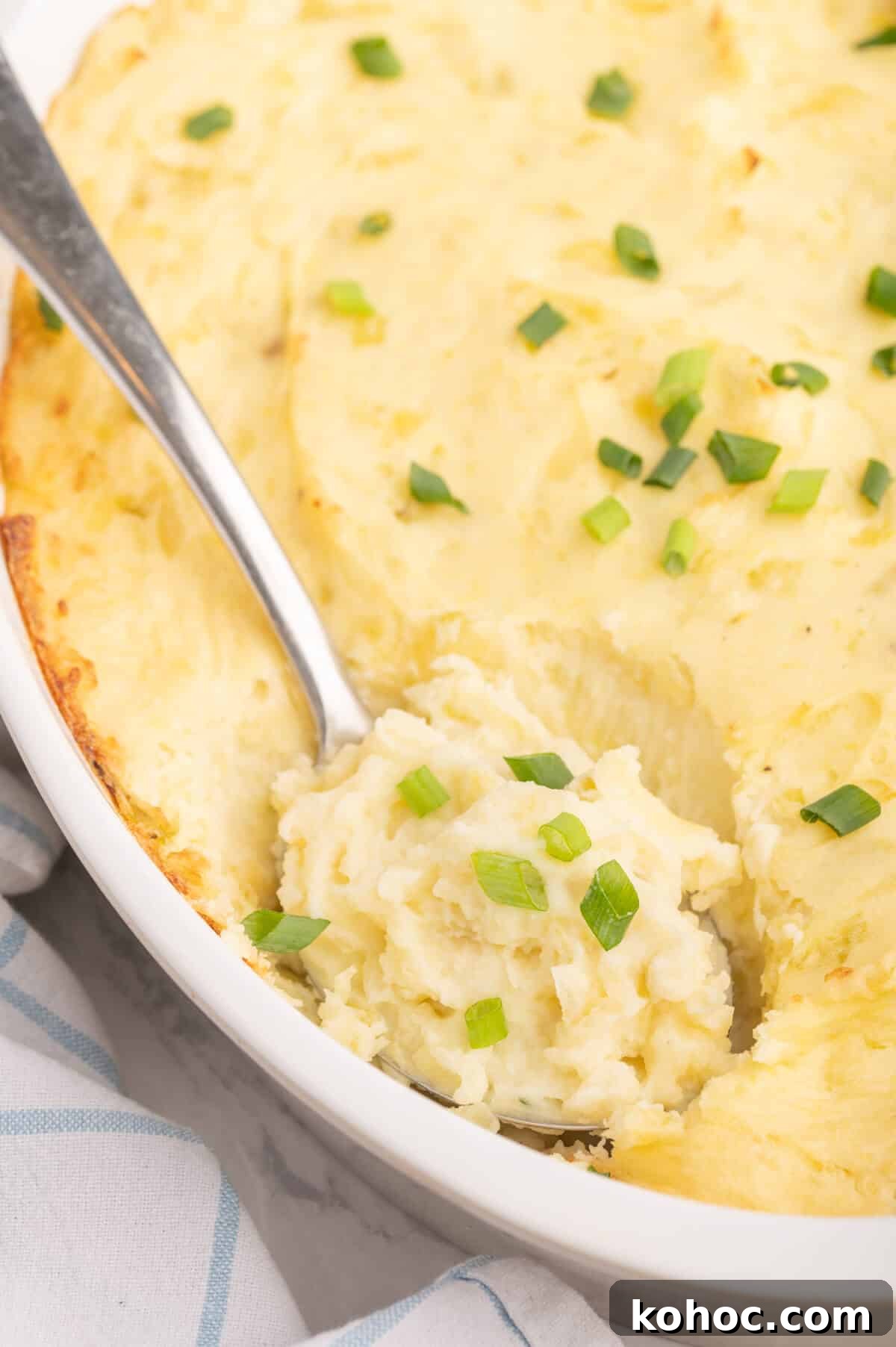 How to Cook Authentic Irish Potatoes: Classic Recipes & Tips 7 A serving spoon in a dish of the potatoes.