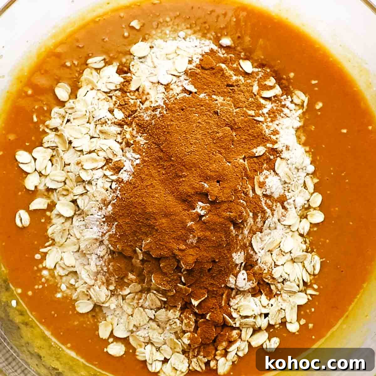 Moist Pumpkin Oatmeal Muffins with Warm Spices 6 adding the dry ingredients to the wet ingredients in the large bowl