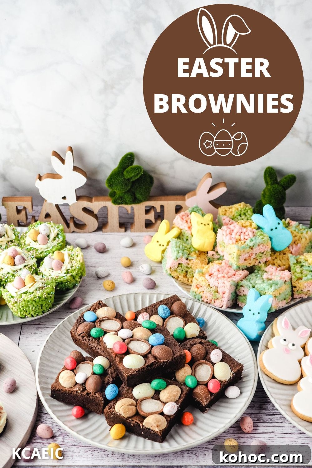 Easter brownies decorated with Easter eggs on a plate, on an Easter dessert table with bunny cookies, Easter rice krispie treats and peeps rice krispie treats in the background.
