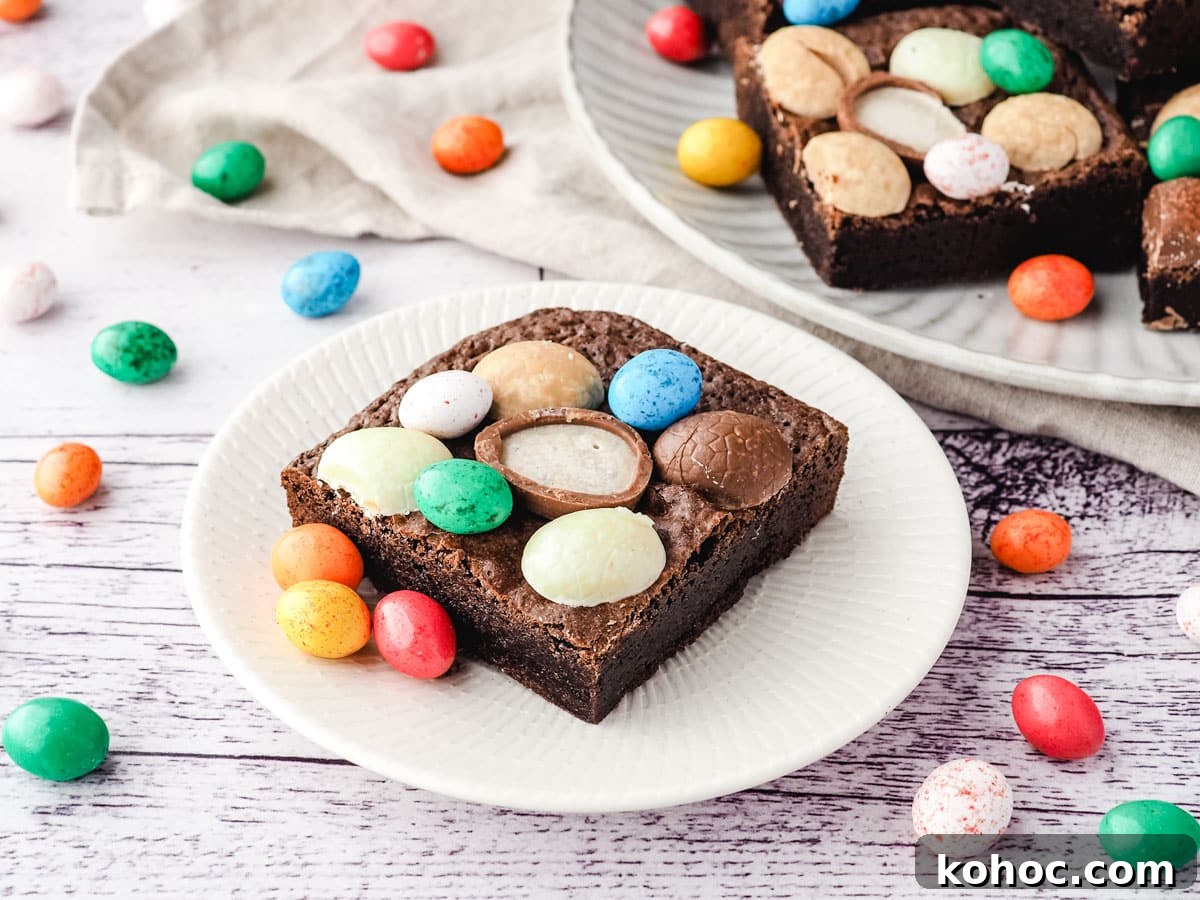 Easter brownie on a plate with extra Easter eggs, and rest of brownies on a plate in the background.