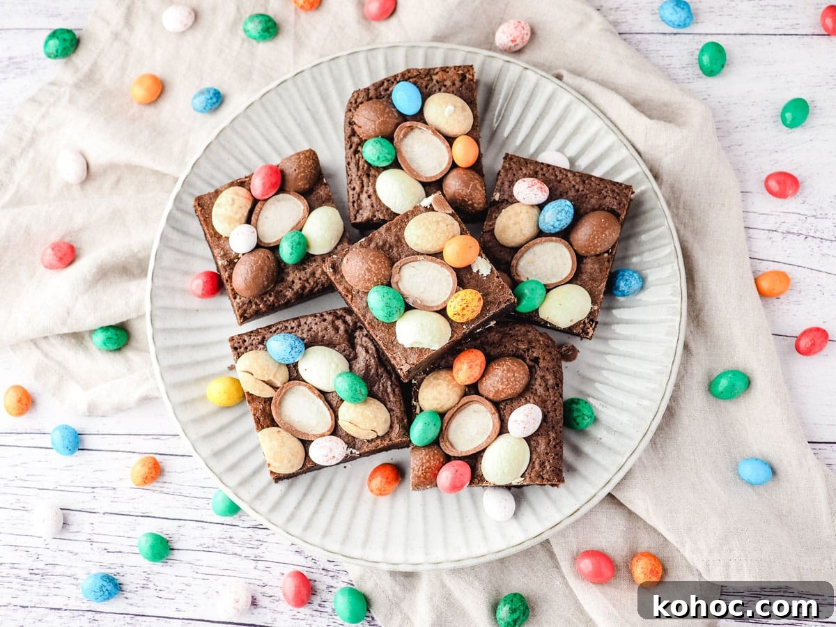 Easter brownies on a plate, surrounded by extra Easter eggs.