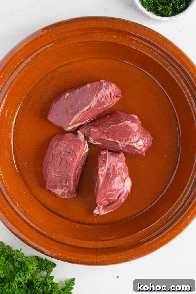 Moroccan Lamb Shank Tangia: Traditional Slow-Cooked Tagine Recipe 4 a tagine with raw lamb shank in it
