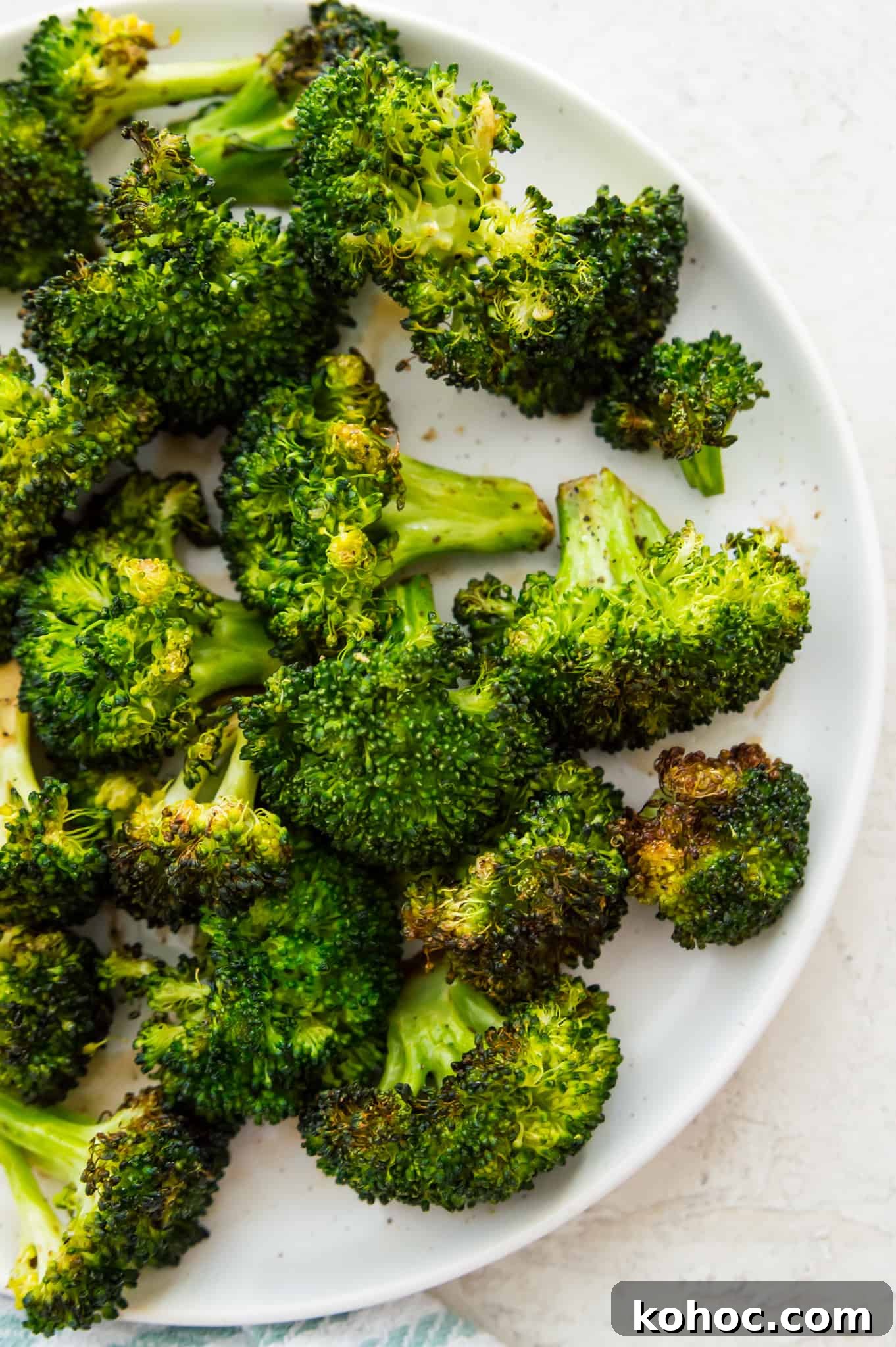Crispy Air Fryer Broccoli Recipe in 15 Minutes 6 A plate with cooked broccoli on it.