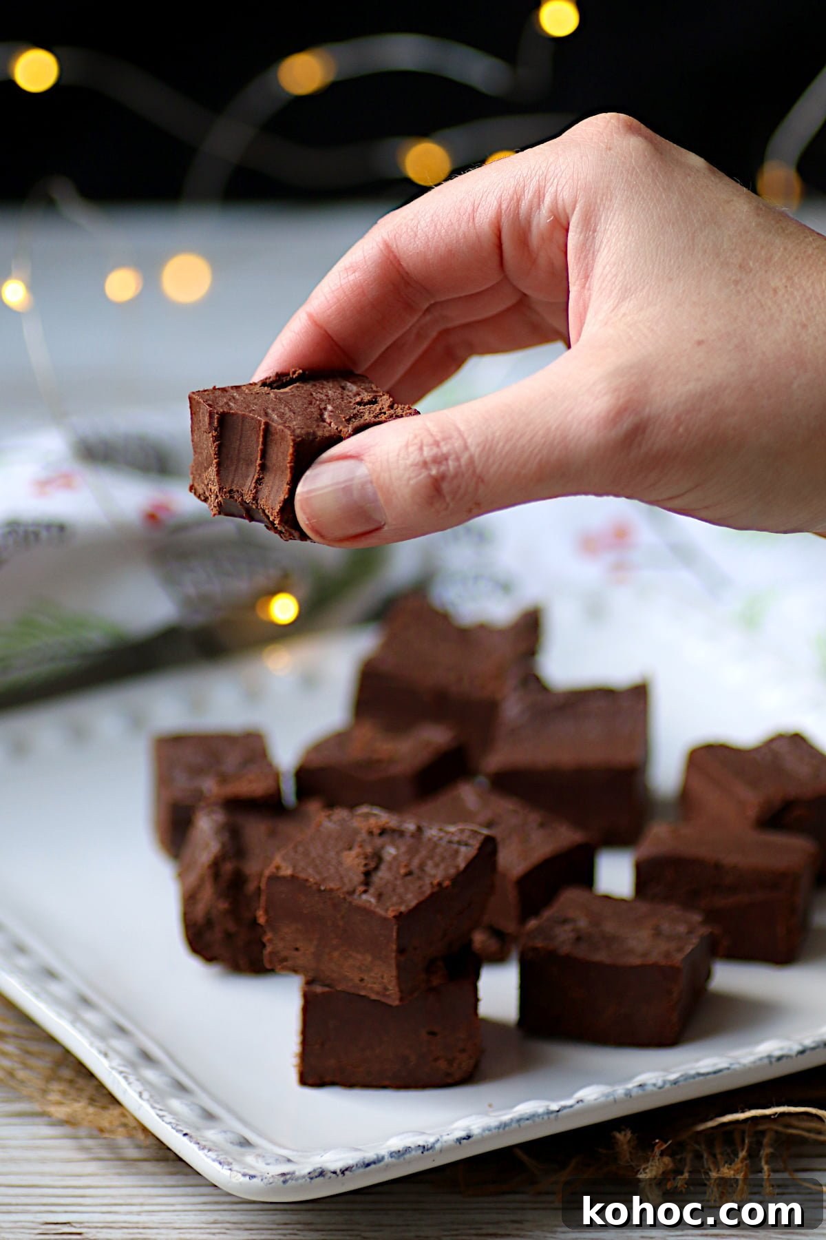 Homemade Frango Mint Chocolates: Chocolate Mint Melts Recipe 4 A hand holding a homemade, Copycat Frango Mint that has a bite missing.